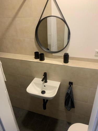 a bathroom with a sink and a mirror at Apartment in zentraler Lage in Willich in Willich