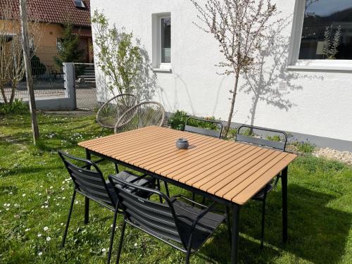 a wooden table and chairs in a yard at Bohlinger Seeapartments in Bohlingen