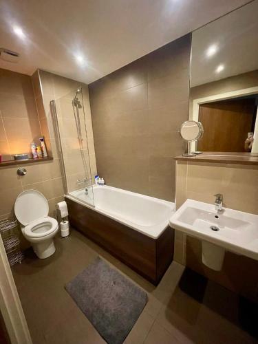 ein Badezimmer mit einer Badewanne, einem WC und einem Waschbecken in der Unterkunft The Riverside in Manchester