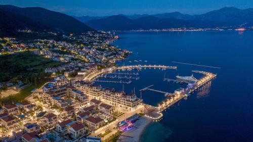 an aerial view of a marina at night at Family House with pool & sea view in Bijela
