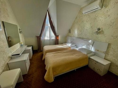 a hotel room with two beds and a window at VitaPark Stariy Dub in Truskavets