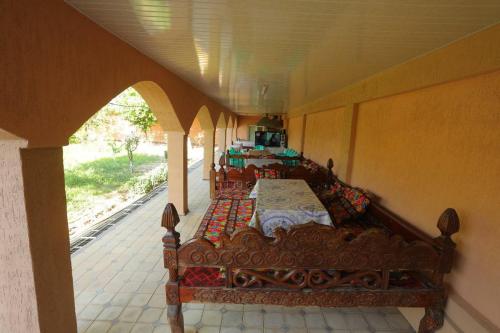 a room with four beds in it with an archway at Сабзавот Давр Дача in Yalanghoch