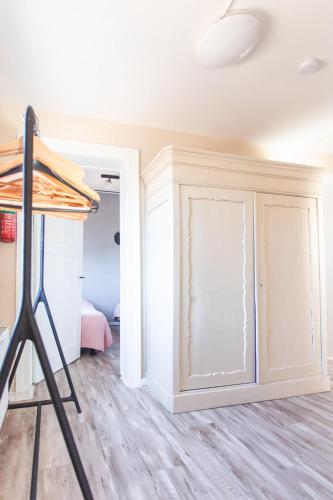 a room with a closet with white cabinets at Stijlvolle @ luxe vrijstaande woning Maastricht in Eijsden