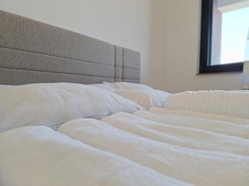 a row of white beds in a room at RIVIJERA CITY in Belgrade