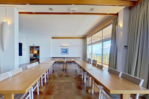a conference room with tables and chairs and a large window at Alivi in Bastia
