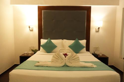 a hotel room with a bed with towels on it at Hotel Clarks Collection Bhavnagar in Bhavnagar