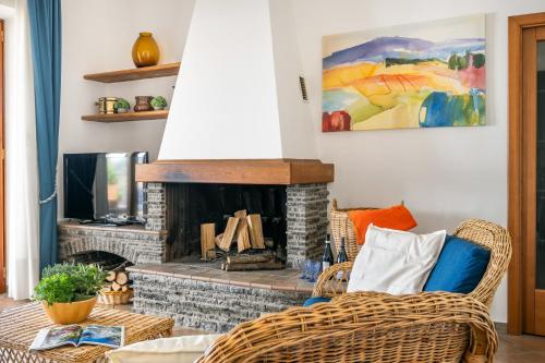 a living room with a fireplace and a couch at Villa Antonella in Vico Equense
