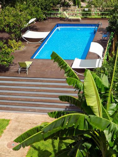 a swimming pool with stairs leading to a resort at Medea Residence appartamenti vacanze in Taormina
