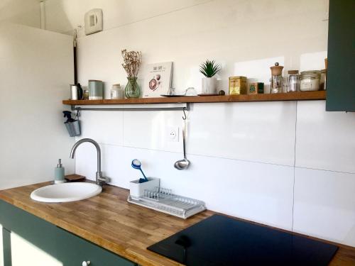 a kitchen with a sink and a counter with a sink at Perfect for couples+children / baby friendly /50m² in Paris