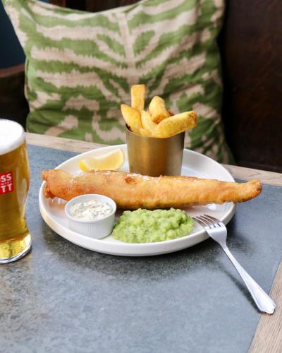 a plate of food with a fish stick and french fries at Tower Hotel in Lincoln
