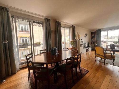 un salon avec une table et des chaises de salle à manger dans l'établissement 16ème - Près Trocadéro, Quartier Prestigieux, à Paris