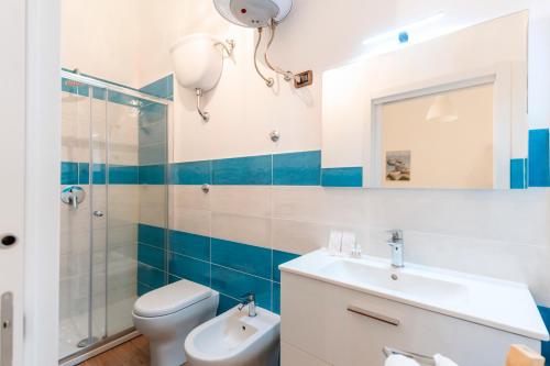 a bathroom with a sink and a toilet and a mirror at Piazza Tasso Suite in Sorrento