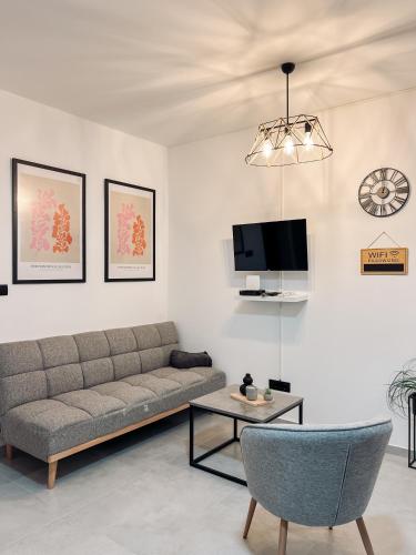 a living room with a couch and a table at Mimista Apartment in Tivat