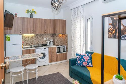 een woonkamer met een bank en een keuken bij Modern Apt Upon Tsimiski in Thessaloniki
