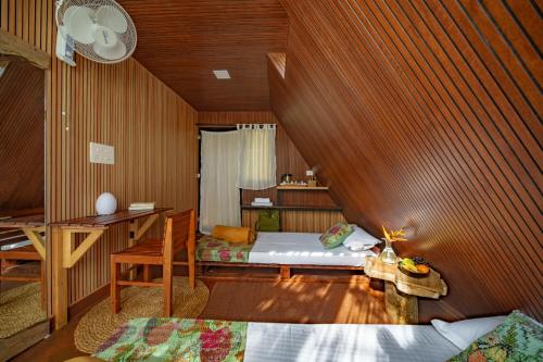 a bedroom with a bed and a desk in it at Aya natural in Ūdumbanshola
