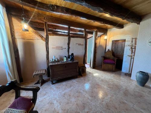 a living room with a table and chairs in a room at Le Relais des Chevaliers "La Suite des Seigneurs" in Cordes-sur-Ciel