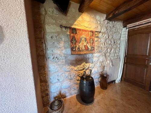 a room with a painting on a stone wall at Le Relais des Chevaliers "La Suite des Seigneurs" in Cordes-sur-Ciel