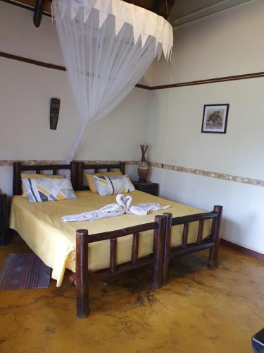 a bedroom with a large bed in a room at Thokozani Lodge in White River