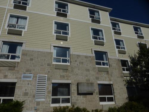 an apartment building with windows on the side of it at Super 8 by Wyndham Peterborough in Peterborough