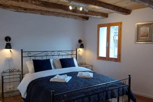 a bedroom with a bed with two towels on it at Casa Lina (Unesco zone) in Segusino