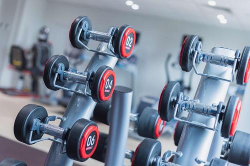 a row of dumbbells in a gym at Hilton Garden Inn Birmingham Airport Uk in Bickenhill