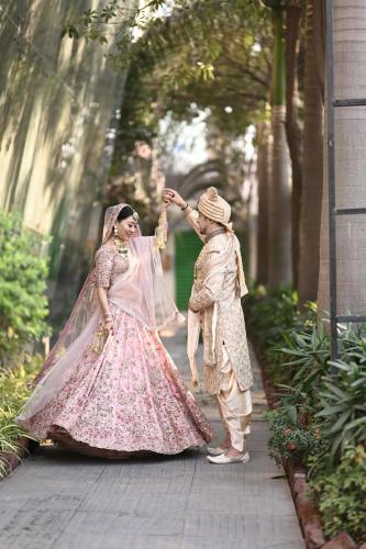 two women in dresses are walking down a sidewalk at Radisson Blu Hotel Pune Kharadi in Pune