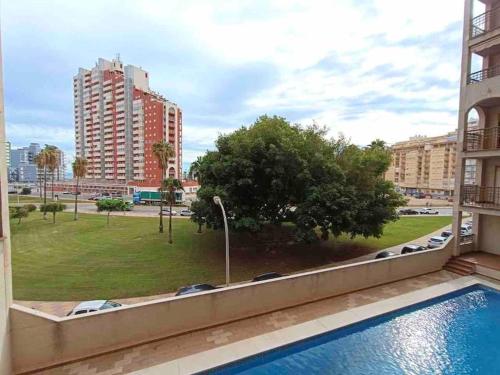 a view of a park from the balcony of a apartment at Pueblo Español in Cullera