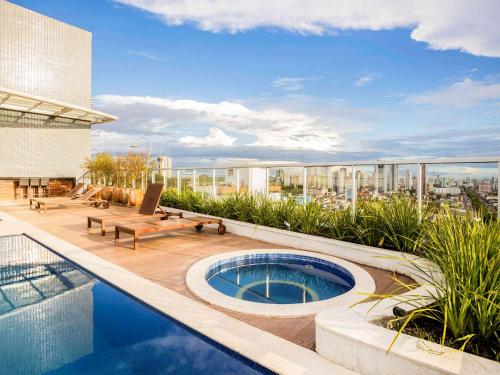 a swimming pool on the roof of a building at Ibis Styles Belém Hangar in Belém