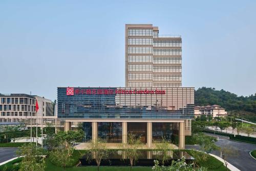 a building with a sign on top of it at Hilton Garden Inn Zhuhai Jinan University in Zhuhai