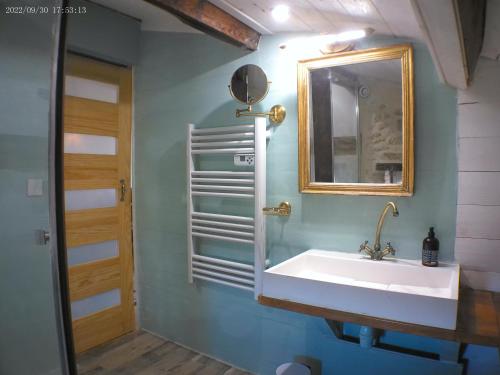 a bathroom with a sink and a mirror at le mas de lombreyra in Massugas