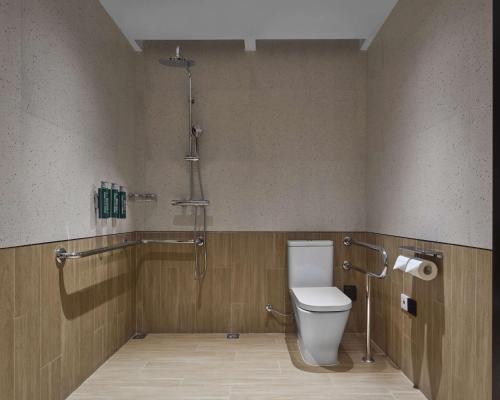 a bathroom with a toilet and a shower at Hilton Garden Inn Kunming Dianchi in Kunming