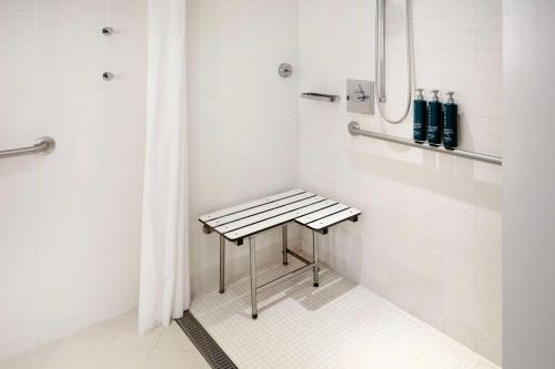 a shower with a bench in a bathroom at Hilton Vacation Club The Modern Honolulu in Honolulu