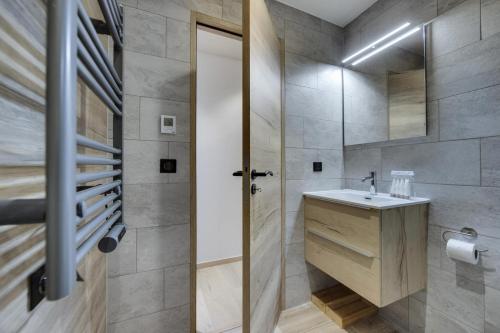 a bathroom with a sink and a mirror at Résidence Auberge Jerome - 4 Pièces pour 8 Personnes 014 in Arc 1950