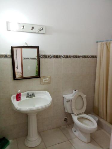 a bathroom with a sink and a toilet and a mirror at Coronado coronado in Playa Coronado