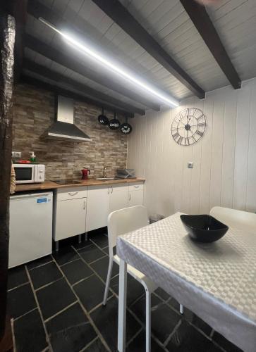 a kitchen with a table with a bowl on it at Complejo la Regalina in Cadavedo