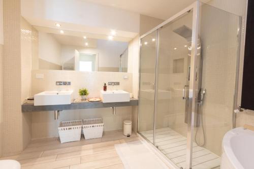 a bathroom with two sinks and a shower at Realkasa Urbana Luxury Apt in Bologna