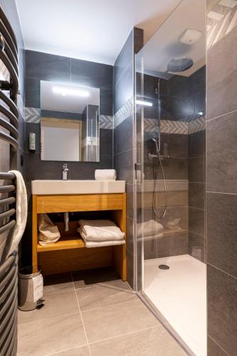 a bathroom with a sink and a shower at Le Hameau des Oursons in Arc 1950