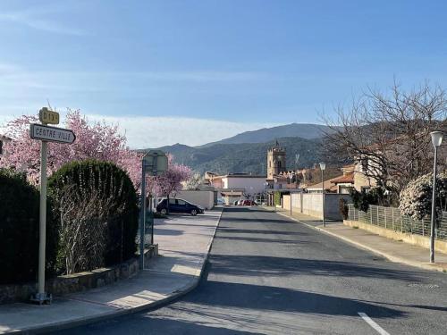an empty street with a street sign and trees at TiLLEY lounge Tiny house in Vinça