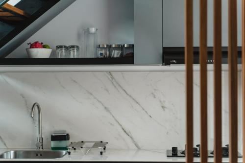a kitchen with a sink and a counter top at Deluxe apartments Canggu area with gym coworking security parking and full services in Tumbak Bayuh