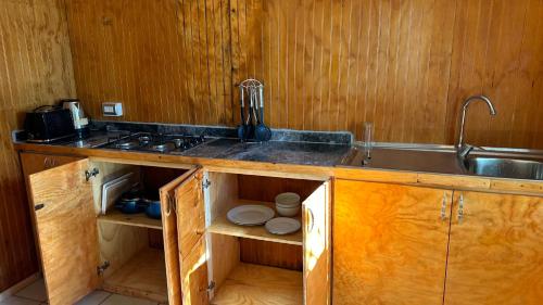 a kitchen with a sink and a counter top at Cabañas Mahatua in Hanga Roa