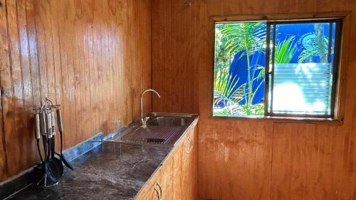 a kitchen with a sink and a window at Cabañas Mahatua in Hanga Roa