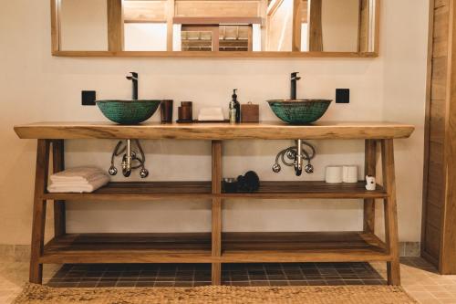 łazienka z 2 umywalkami na drewnianym blacie w obiekcie July Villas w mieście Canggu
