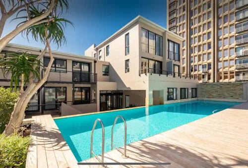a swimming pool in front of a building at Art Deco Loft, CBD, No Black Outs! in Cape Town