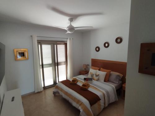 a bedroom with a bed and a ceiling fan at Villa La Tunera in Costa de Antigua