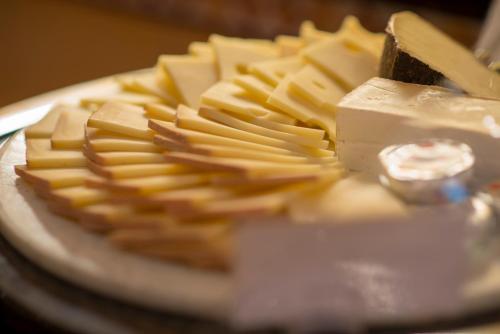a plate of cheese and crackers on a table at Hotel Krone Unterstrass in Zürich