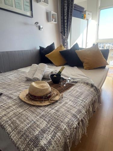 a bed with a straw hat and glasses on it at Estudio Edificio Almirante in Mijas Costa