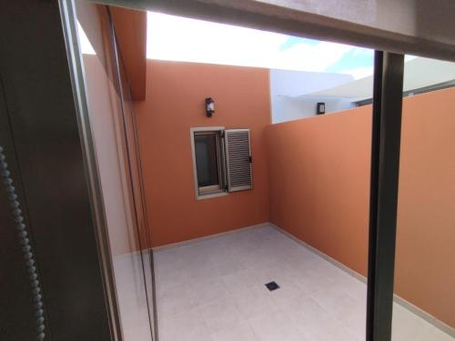 a room with orange walls and a window at Villa La Tunera in Costa de Antigua