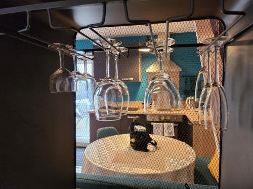 a room with a table and four wine glasses at Gite MERLIN Spa Privatif et Sauna in Trélévern