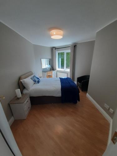 a small bedroom with a bed and a window at Eden Lodge in Bantry