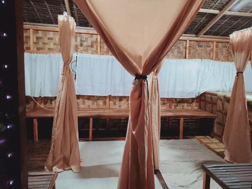 a room with a curtain and a table and a window at WELLNESS & FITNESS IN LIFE LA UNION fan kubo 4 pax 1 min to beach in Rimus